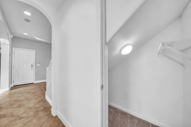 a large kitchen with stainless steel appliances granite countertop a refrigerator a sink and a stove