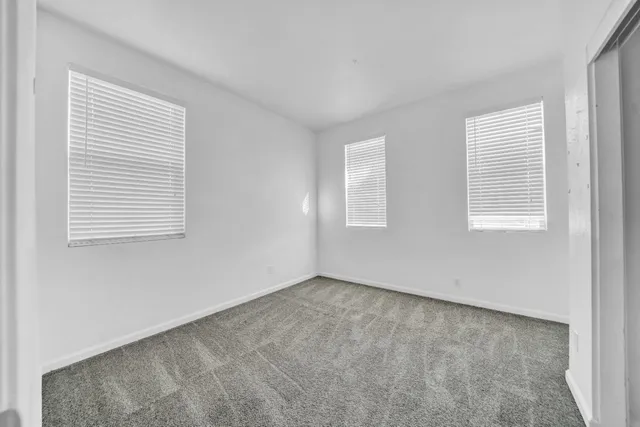 a spacious bathroom with a granite countertop sink a toilet and a granite