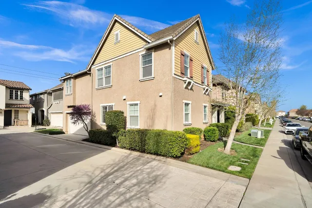 a view of a white house with a yard