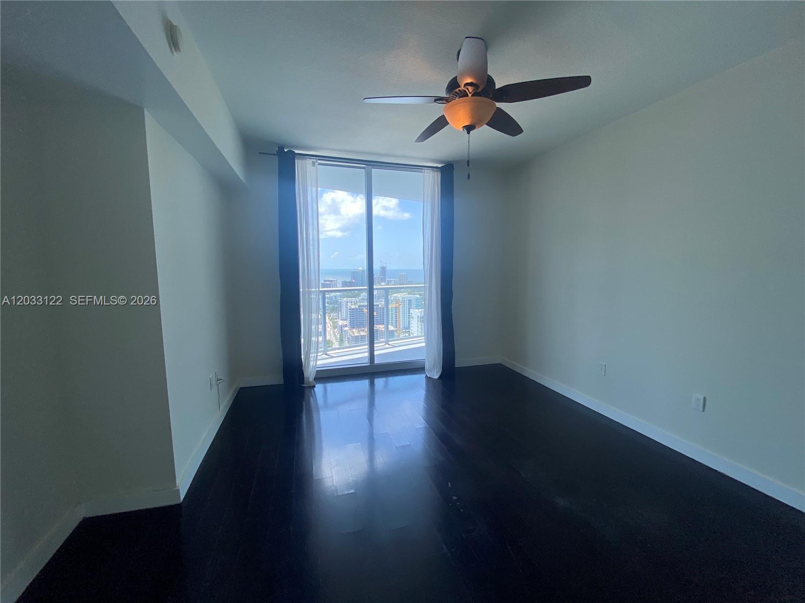 185 Southwest 7th Street, Unit 4206 Miami, FL 33130 - Photo 12 of 26 a view of livingroom with hardwood floor and a ceiling fan