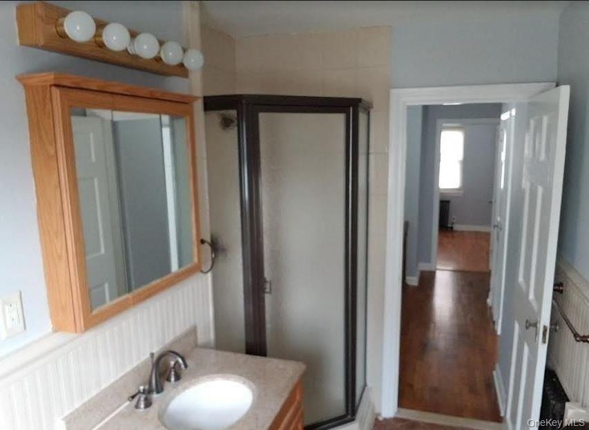 136-48 71st Road Queens, NY 11367 - Photo 11 of 13 a bathroom with a sink and a mirror