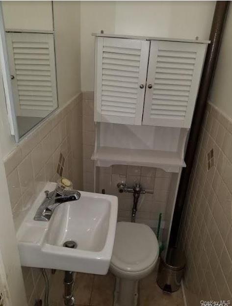 136-48 71st Road Queens, NY 11367 - Photo 12 of 13 a bathroom with a sink and a toilet