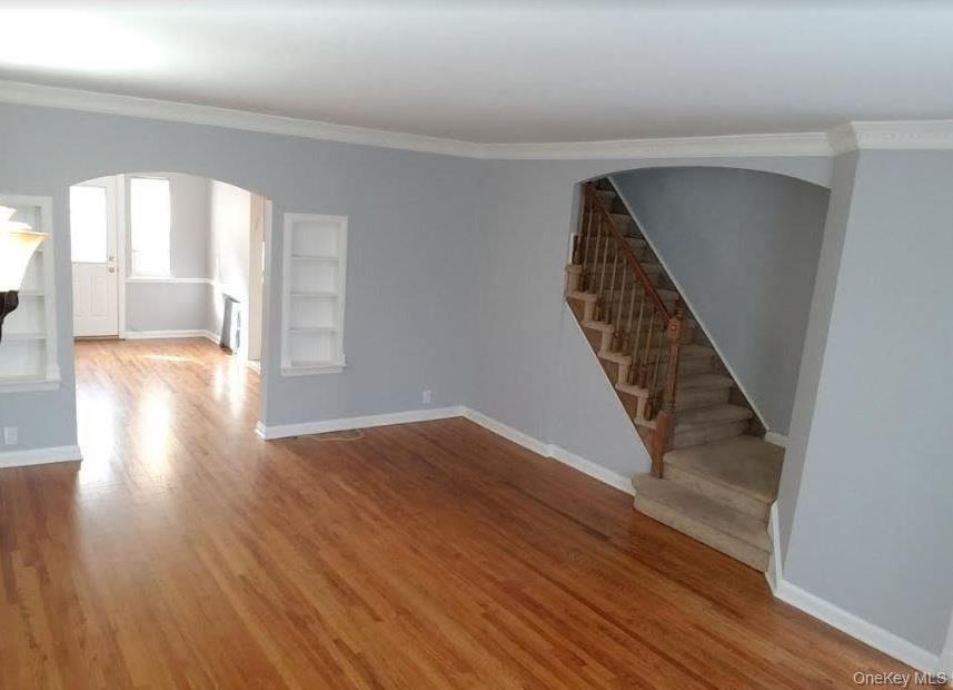 136-48 71st Road Queens, NY 11367 - Photo 4 of 13 wooden floor in an empty room with a window