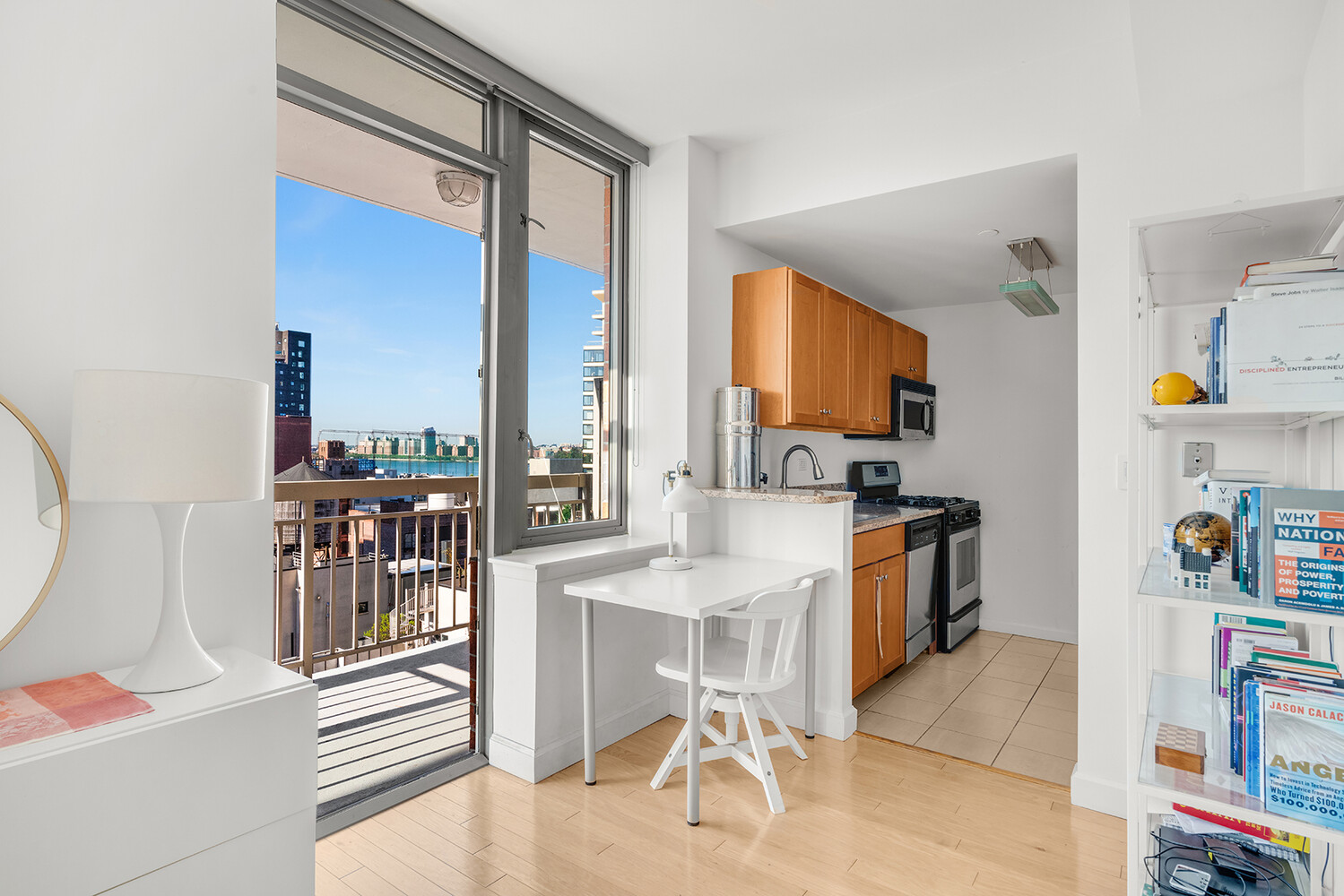 520 West 23rd Street, Unit 14G Manhattan, NY 10011 - Photo 3 of 7 a kitchen with stainless steel appliances granite countertop a refrigerator and a stove