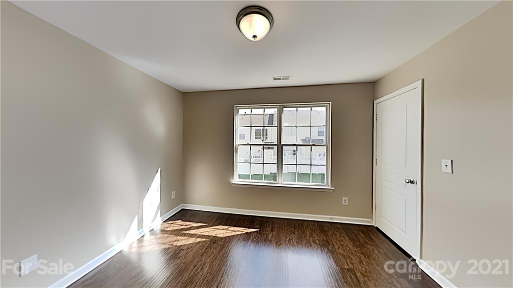 847 Gentlewinds Court Fort Mill, SC 29708 - Photo 11 of 13 an empty room with wooden floor and windows