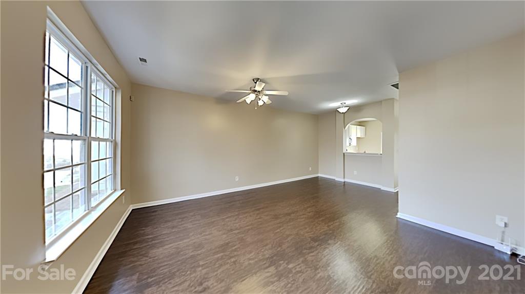 847 Gentlewinds Court Fort Mill, SC 29708 - Photo 3 of 13 a view of an empty room with a window and wooden floor