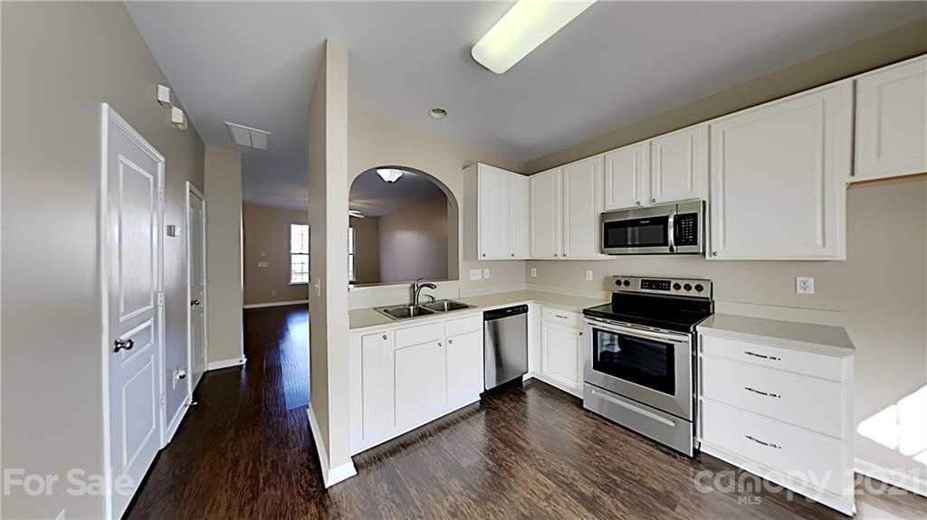 847 Gentlewinds Court Fort Mill, SC 29708 - Photo 4 of 13 a kitchen with stainless steel appliances a stove sink and microwave