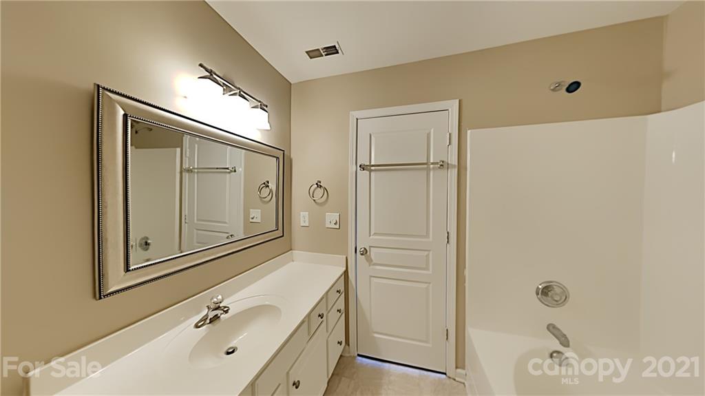 847 Gentlewinds Court Fort Mill, SC 29708 - Photo 10 of 13 a bathroom with a tub sink vanity and mirror