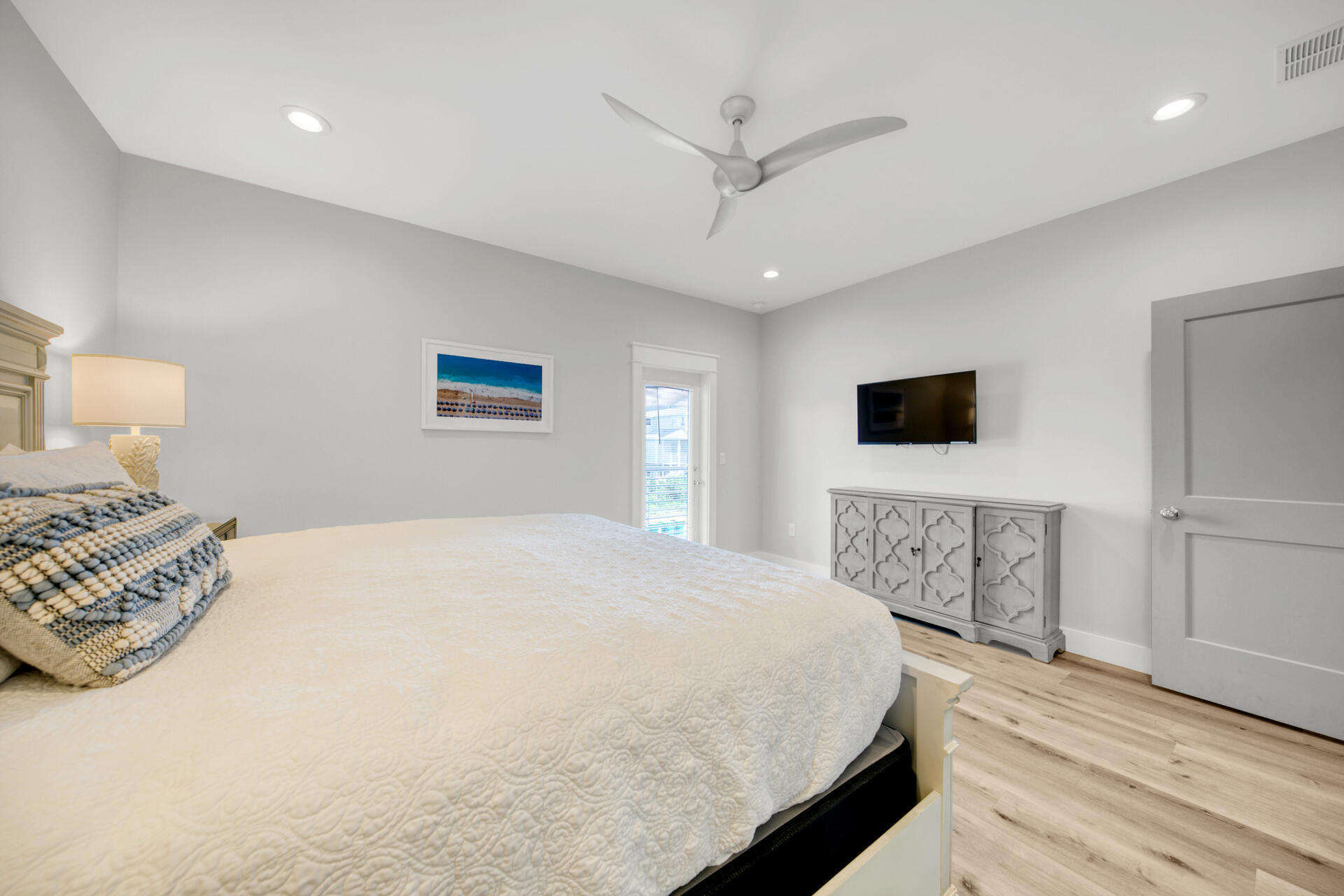 106 Shirah Street Destin, FL 32541 - Photo 18 of 67 a spacious bedroom with a bed and a flat screen tv