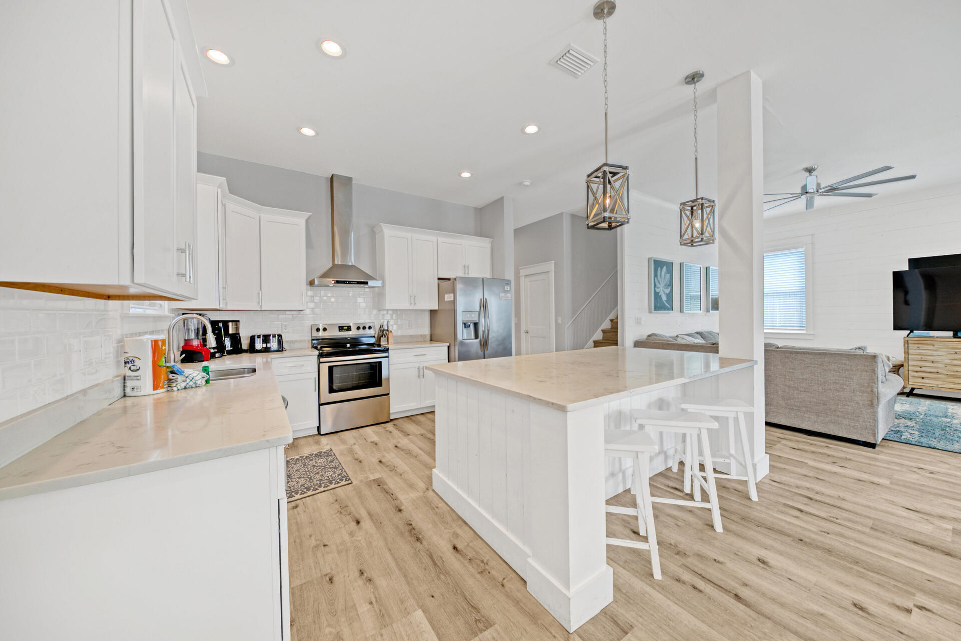 106 Shirah Street Destin, FL 32541 - Photo 3 of 67 a kitchen with stainless steel appliances granite countertop a sink a stove a refrigerator and island with wooden floor