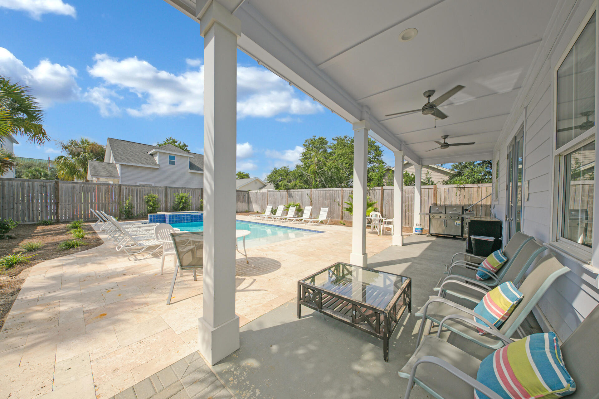106 Shirah Street Destin, FL 32541 - Photo 55 of 67 a view of a patio with couches table and chairs and potted plants