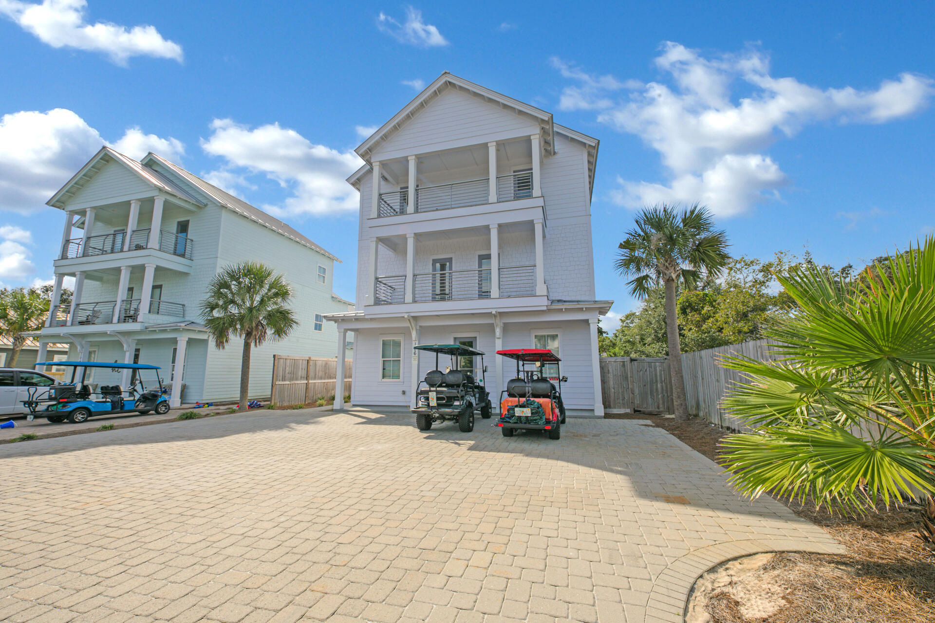 106 Shirah Street Destin, FL 32541 - Photo 62 of 67 a view of a brick house with many windows and a table and chairs in patio