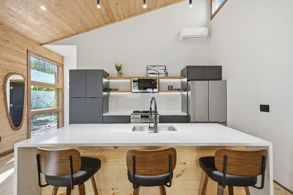 138 Cottonwood Lane Blue Ridge, GA 30513 - Photo 11 of 35 a kitchen with stainless steel appliances a table chairs and wooden floor