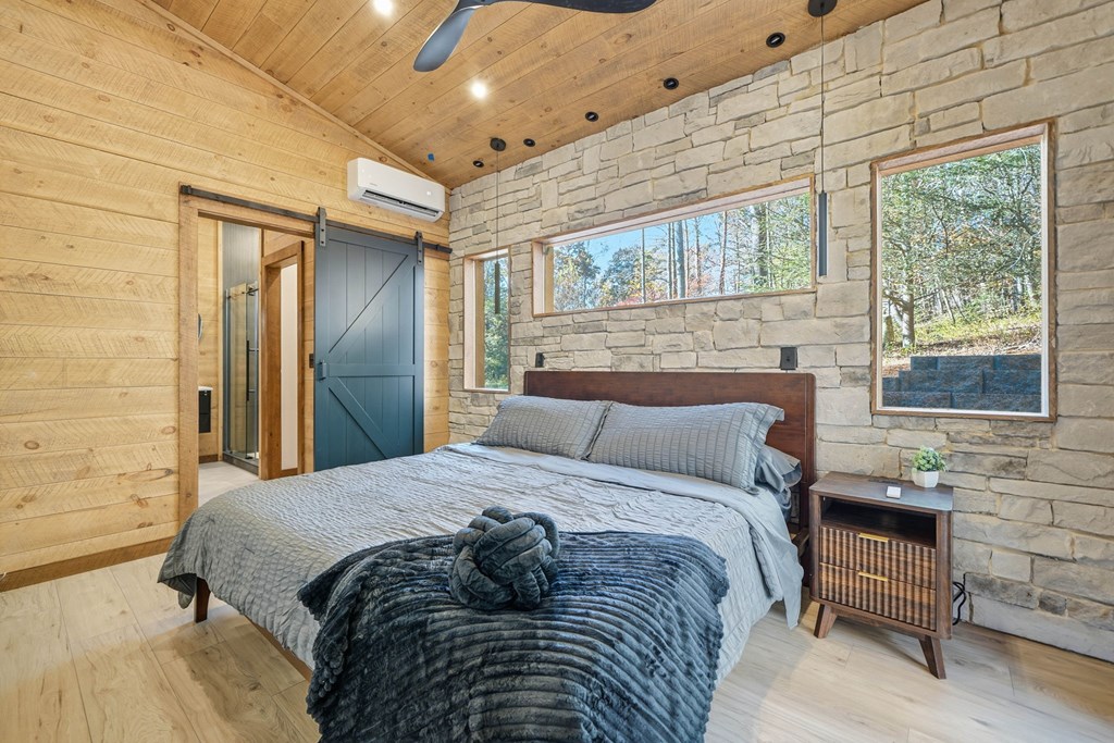 138 Cottonwood Lane Blue Ridge, GA 30513 - Photo 19 of 35 a large bed sitting in a bedroom next to a balcony