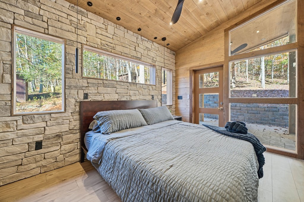 138 Cottonwood Lane Blue Ridge, GA 30513 - Photo 20 of 35 a bedroom with a bed next to a large window with outer view