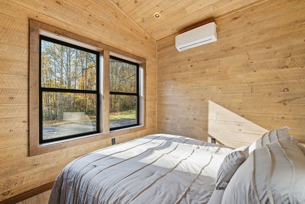 138 Cottonwood Lane Blue Ridge, GA 30513 - Photo 28 of 35 a bedroom with a bed and a large window