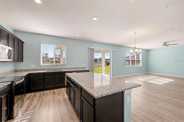 a kitchen with granite countertop cabinets a counter space and a sink