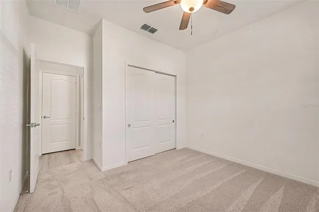 a view of a livingroom with a ceiling fan and window