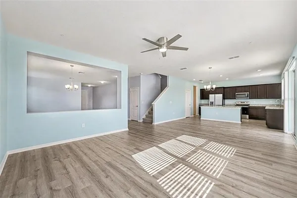 a view of a living room a kitchen and a wooden floor