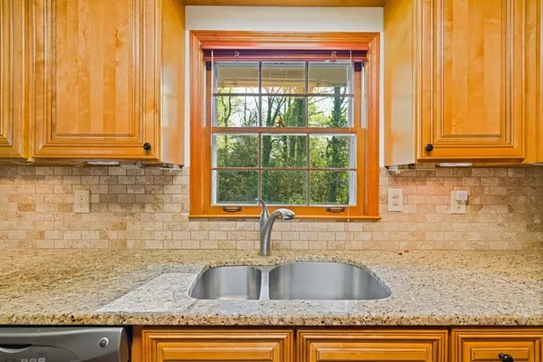 a kitchen with granite countertop a sink and a window