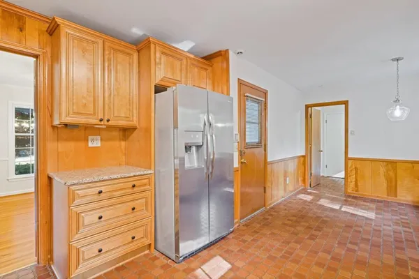a kitchen with granite countertop cabinets stainless steel appliances and a counter space