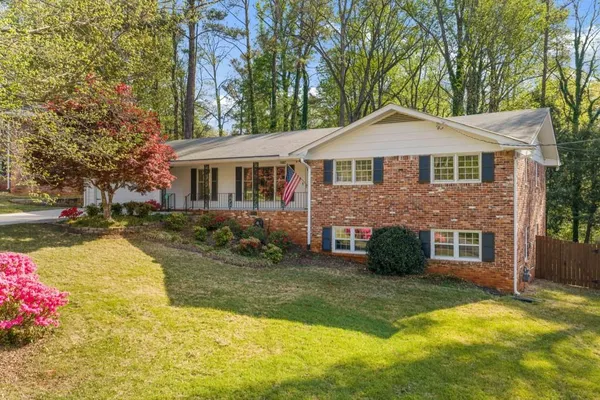a view of a house with a yard and tree s
