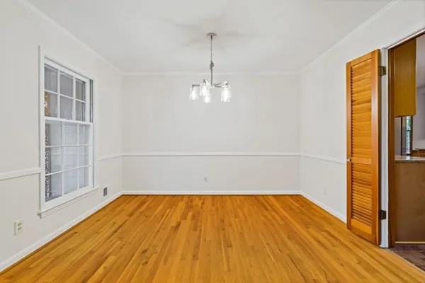 a view of a room with wooden floor and windows