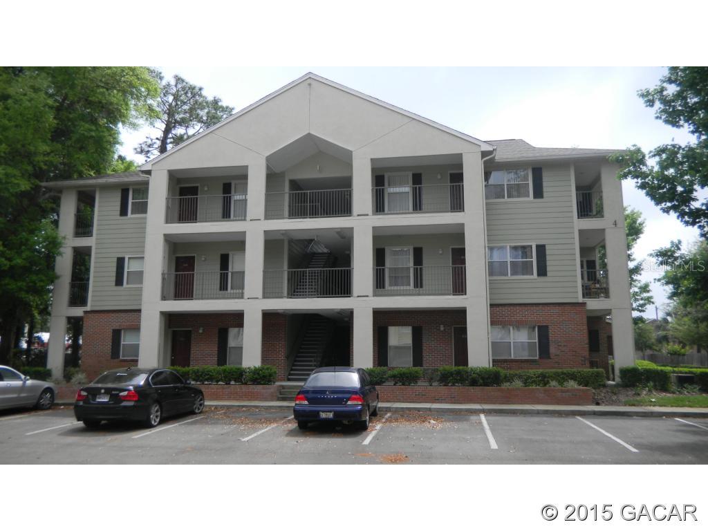 2360 Southwest Archer Road, Unit 502 Gainesville, FL 32608 - Photo 1 of 1 a black and white photo of a building