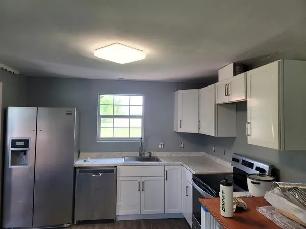 a kitchen with a refrigerator stove and sink
