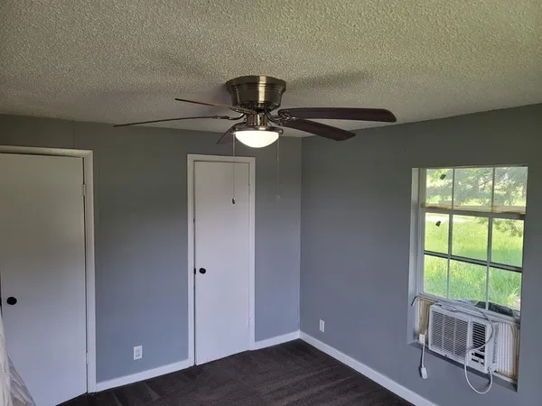 a work room with windows and ceiling fan