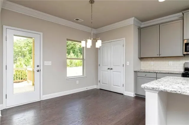 a view of a kitchen with an empty space and a window