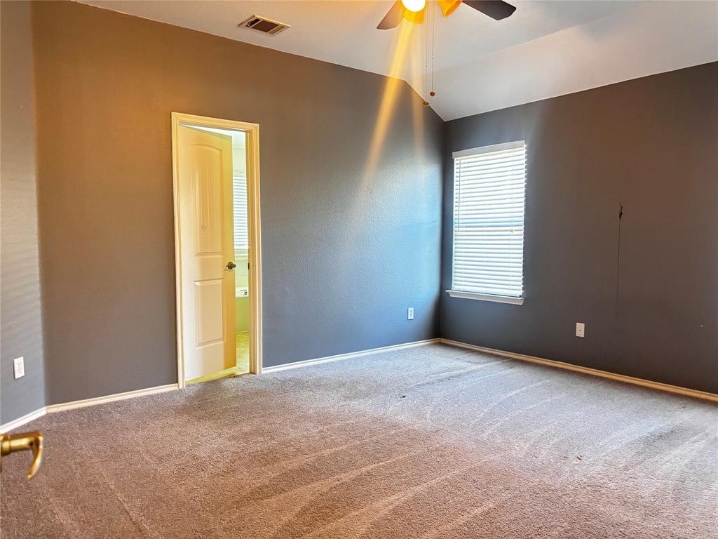 9704 Mystic Dunes Drive McKinney, TX 75072 - Photo 11 of 17 a view of an empty room with window and chandelier fan