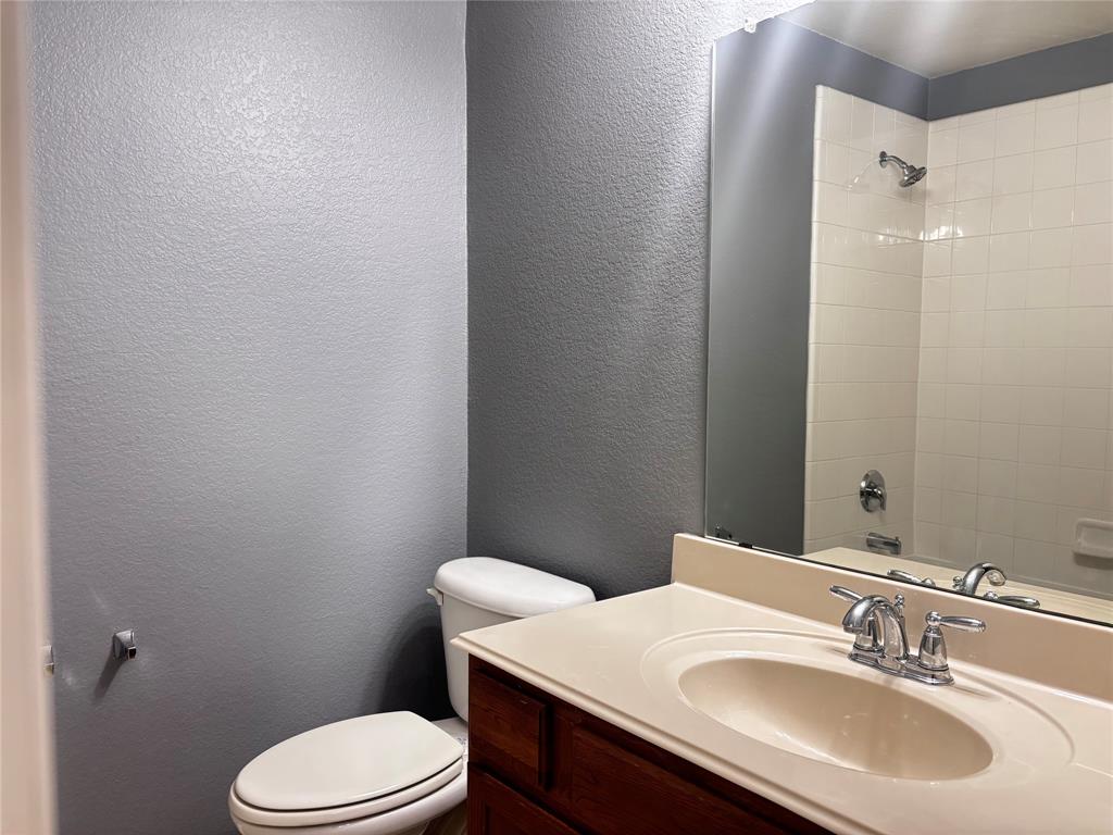 9704 Mystic Dunes Drive McKinney, TX 75072 - Photo 6 of 17 a bathroom with a sink a toilet a mirror and shower