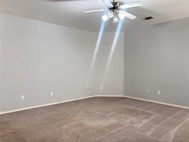 a view of an empty room with a fan