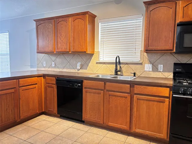a kitchen with stainless steel appliances granite countertop a refrigerator and sink