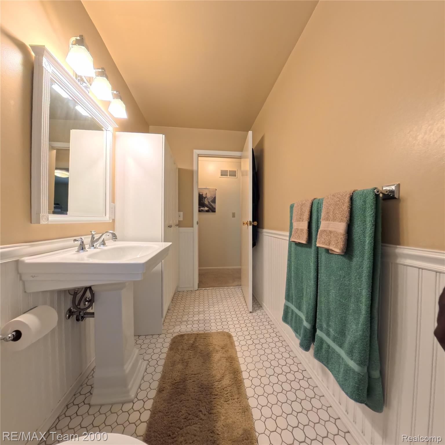 2104 Whittier Road Ypsilanti, MI 48197 - Photo 19 of 45 Bathroom with wainscoting and a sink