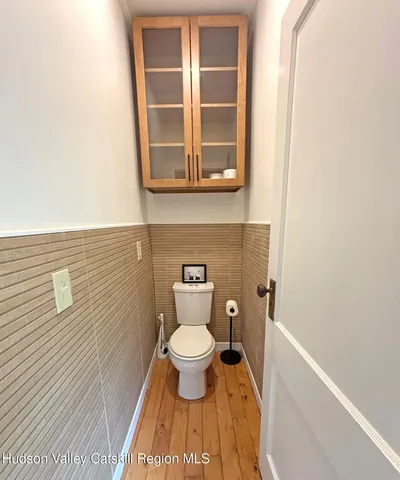 a bathroom with a toilet and a window