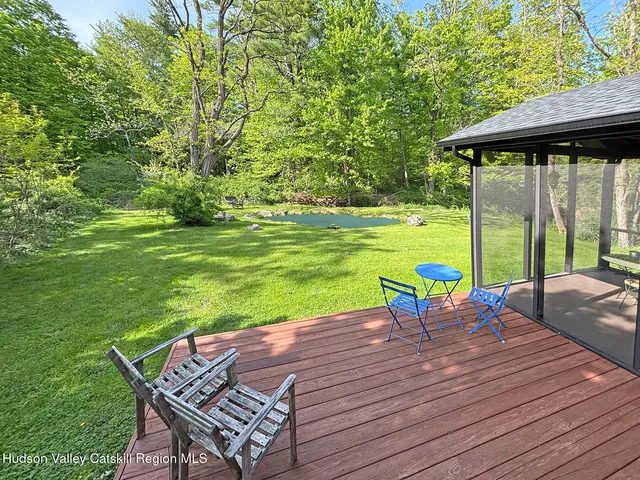 a view of a patio with table and chairs potted plants with large tree