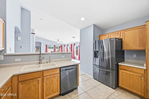 a kitchen with stainless steel appliances granite countertop a refrigerator and a sink