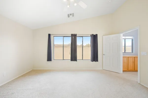 an empty room with windows and closet