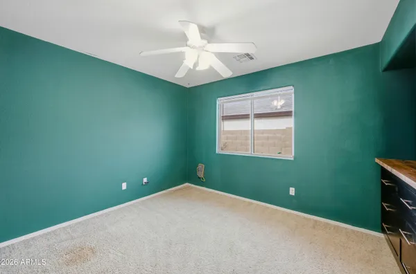 a view of a room that has a fan and a window