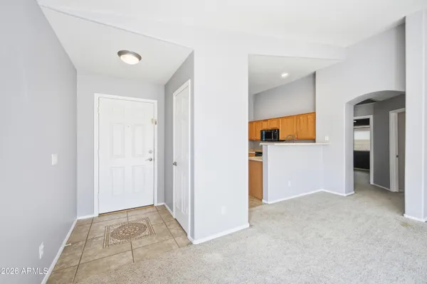 an empty room with closet and a bathroom