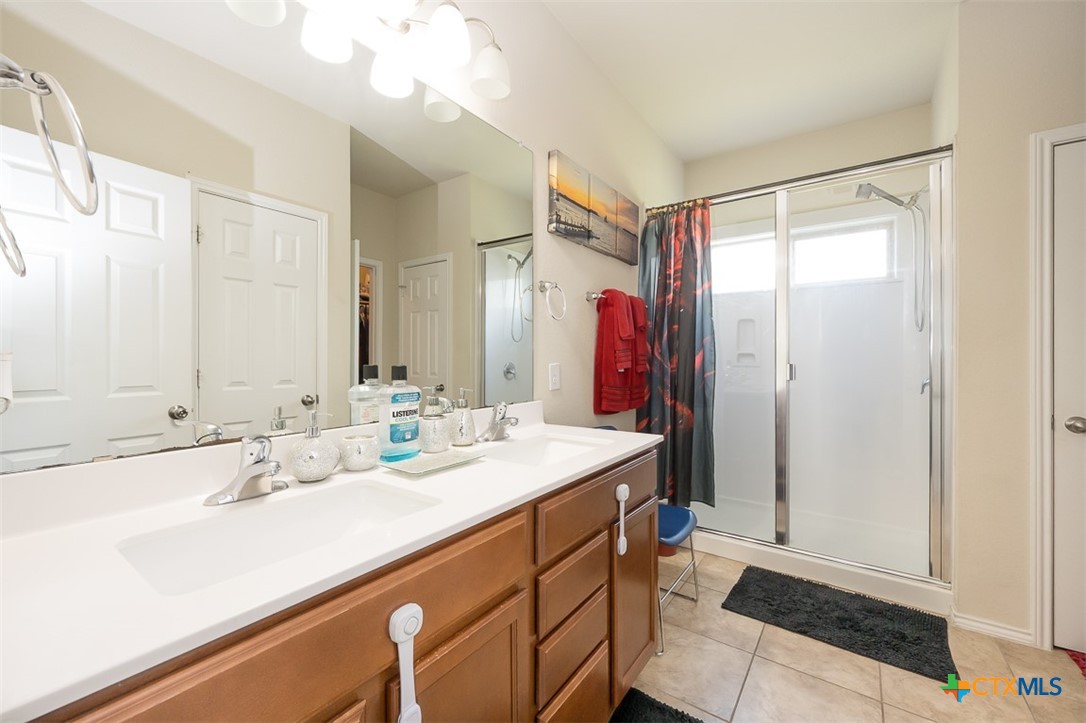 2511 Pintail Loop Copperas Cove, TX 76522 - Photo 16 of 26 a bathroom with a sink and a mirror