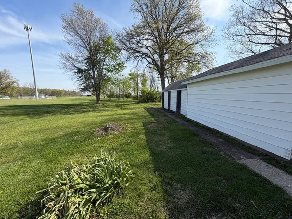 a view of a backyard with large trees