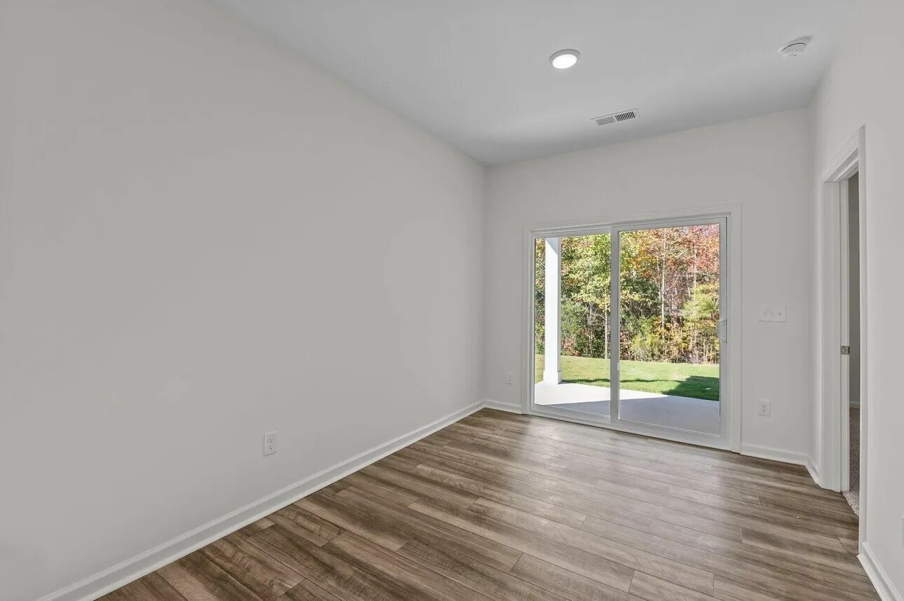 31022 Gayle Prairie Oaks Street Waller, TX 77484 - Photo 4 of 8 a view of an empty room with wooden floor and a window