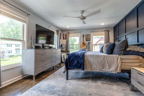 a bedroom with a bed window and a television