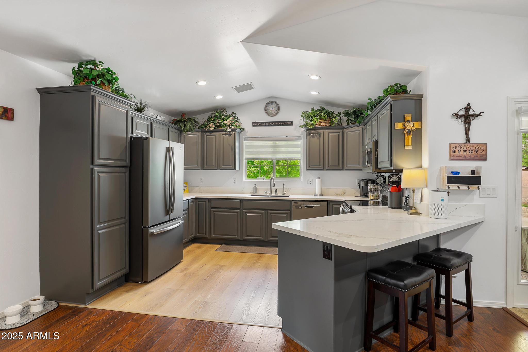 317 East Pine Street Payson, AZ 85541 - Photo 15 of 25 a kitchen with granite countertop a refrigerator a sink a stove a dining table and chairs