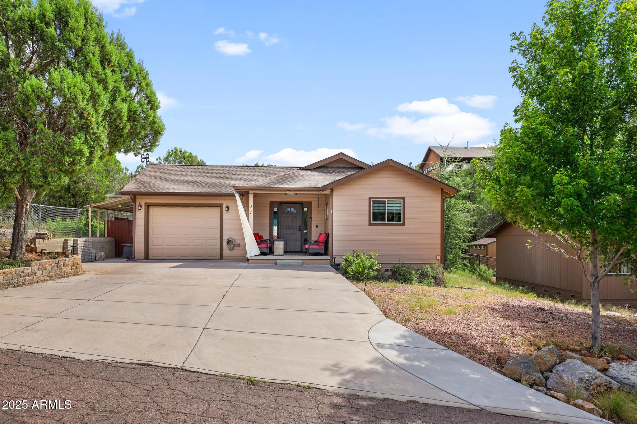 317 East Pine Street Payson, AZ 85541 - Photo 2 of 25 a front view of a house with a yard and garage