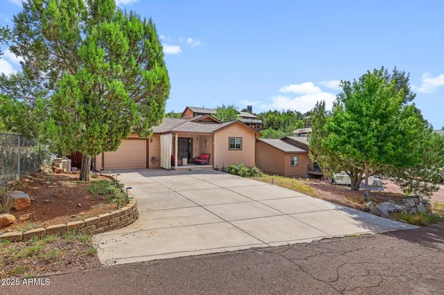 a front view of a house with a yard and a garage
