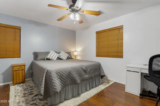 a bedroom with a bed and a tv on the dresser